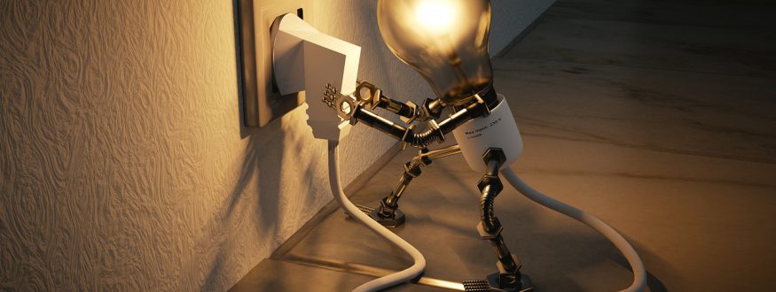 A little bot with a light bulb for a head plugging itself into a wall socket.
